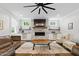 Cozy living room with stone fireplace, built in cabinets and lots of natural light at 125 Lord Ashley Rd, Raleigh, NC 27610