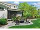 Backyard patio featuring a fire pit, outdoor seating, and landscaping with blooming flowers at 125 Lord Ashley Rd, Raleigh, NC 27610