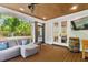 Inviting screened-in patio with comfortable seating, wood flooring, and view of the backyard at 125 Lord Ashley Rd, Raleigh, NC 27610