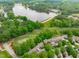 Aerial view of property with lake, golf course, lush green trees and surrounding community at 1305 Queensferry Rd, Cary, NC 27511