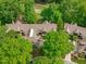 An aerial view of a beautiful home nestled among lush green trees near a golf course at 1305 Queensferry Rd, Cary, NC 27511