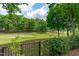 Landscaped backyard provides serene golf course views, enhancing outdoor living at 1305 Queensferry Rd, Cary, NC 27511