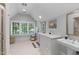 Spacious bathroom with dual vanities, large window with plantation shutters, and walk-in shower at 1305 Queensferry Rd, Cary, NC 27511
