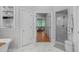 Bright bathroom featuring marble floors, soaking tub, shower, and entryway to bedroom at 1305 Queensferry Rd, Cary, NC 27511