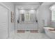 Elegant bathroom with marble floors, double vanity, and a soaking tub next to a shuttered window at 1305 Queensferry Rd, Cary, NC 27511