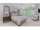Stylish bedroom featuring soft neutral colors, plantation shutters, and decorative pillows at 1305 Queensferry Rd, Cary, NC 27511