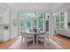 Elegant dining room featuring a chandelier, hardwood floors, and large windows at 1305 Queensferry Rd, Cary, NC 27511