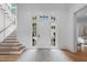 Inviting foyer with a staircase, hardwood floors, and ample natural light at 1305 Queensferry Rd, Cary, NC 27511