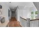 Bright hallway featuring hardwood floors, stylish decor, statement windows, and crown moulding at 1305 Queensferry Rd, Cary, NC 27511