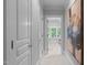 Hallway with classic trim detail leading to bedroom with view of window with plantation shutters at 1305 Queensferry Rd, Cary, NC 27511
