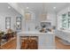 Open-concept kitchen featuring marble countertops, custom cabinetry, and island with seating at 1305 Queensferry Rd, Cary, NC 27511