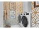 Stylish laundry room with patterned wallpaper and modern white washer and dryer at 1305 Queensferry Rd, Cary, NC 27511