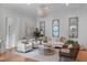 Comfortable living room featuring stylish seating, decorative mirrors, and a modern chandelier at 1305 Queensferry Rd, Cary, NC 27511