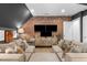 Stylish living room featuring brick wall, built-in entertainment center, and comfortable seating at 1305 Queensferry Rd, Cary, NC 27511