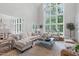 Bright living room with high ceilings, large windows, and stylish furniture at 1305 Queensferry Rd, Cary, NC 27511