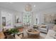 Sun-filled living room showcasing a unique round chandelier and a cozy seating area at 1305 Queensferry Rd, Cary, NC 27511