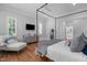 Serene main bedroom with hardwood floors, natural light, and an ensuite bathroom at 1305 Queensferry Rd, Cary, NC 27511