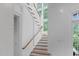 Beautiful staircase with white railings and hardwood steps, illuminated by large windows at 1305 Queensferry Rd, Cary, NC 27511