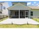 A home's manicured backyard features an outdoor patio and a screened in porch at 1311 Arena Ln, Fuquay Varina, NC 27526