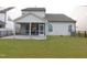 A home's manicured backyard features an outdoor patio and a screened in porch at 1311 Arena Ln, Fuquay Varina, NC 27526