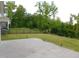 Large backyard featuring a concrete patio, lawn and black metal fence at 1311 Arena Ln, Fuquay Varina, NC 27526