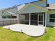 A home's manicured backyard features an outdoor patio and a screened in porch at 1311 Arena Ln, Fuquay Varina, NC 27526