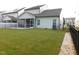 View of the backyard with a screened porch and concrete patio at 1311 Arena Ln, Fuquay Varina, NC 27526