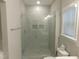 Bathroom features a frameless glass shower with tiled walls and built-in shower niches at 1311 Arena Ln, Fuquay Varina, NC 27526