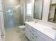 Modern bathroom featuring a walk-in shower, dual vanity, and updated fixtures at 1311 Arena Ln, Fuquay Varina, NC 27526