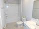 Bright bathroom features white fixtures, including a shower-tub combo and vanity at 1311 Arena Ln, Fuquay Varina, NC 27526