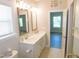 Bright bathroom featuring double sink vanity with granite countertops and framed mirrors at 1311 Arena Ln, Fuquay Varina, NC 27526