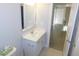 Bathroom vanity features white cabinetry, with a hardwood floor outside the entrance at 1311 Arena Ln, Fuquay Varina, NC 27526