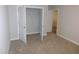Carpeted bedroom features an open closet and a view into the next room at 1311 Arena Ln, Fuquay Varina, NC 27526