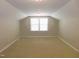 Spacious carpeted bedroom with ceiling fan and a view of the window at 1311 Arena Ln, Fuquay Varina, NC 27526