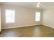 Spacious bedroom with hardwood floors and large windows that offer plenty of natural light at 1311 Arena Ln, Fuquay Varina, NC 27526