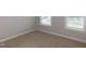 Bedroom with neutral colored carpet and natural light, creating a bright and airy space at 1311 Arena Ln, Fuquay Varina, NC 27526