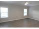 Bedroom with a ceiling fan and two windows providing lots of natural light at 1311 Arena Ln, Fuquay Varina, NC 27526