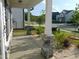 Covered porch with stone pillars, landscaped garden, and street view at 1311 Arena Ln, Fuquay Varina, NC 27526
