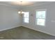 Dining area with hardwood floors, chandelier, and natural light from the view of the outdoors at 1311 Arena Ln, Fuquay Varina, NC 27526