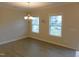 Bright dining room with two windows, modern chandelier and new hardwood floors at 1311 Arena Ln, Fuquay Varina, NC 27526