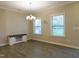 Well-lit dining area featuring a modern chandelier and two bright windows at 1311 Arena Ln, Fuquay Varina, NC 27526