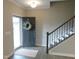 Inviting foyer with staircase, modern flooring, and wreath on the front door at 1311 Arena Ln, Fuquay Varina, NC 27526