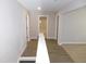 Upstairs hallway features new flooring and fresh paint, offering a clean and bright transition between rooms at 1311 Arena Ln, Fuquay Varina, NC 27526