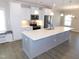 Bright kitchen features a large island, stainless steel appliances, and white cabinetry at 1311 Arena Ln, Fuquay Varina, NC 27526