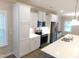 White cabinets and stainless steel appliances, including fridge, microwave and oven at 1311 Arena Ln, Fuquay Varina, NC 27526