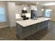 Kitchen featuring stainless steel appliances, a large island, and bright white cabinets at 1311 Arena Ln, Fuquay Varina, NC 27526