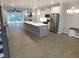 Bright, open kitchen featuring a large island, stainless steel appliances, and lots of light at 1311 Arena Ln, Fuquay Varina, NC 27526