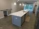 Kitchen island with stainless steel sink and dishwasher, open to living space at 1311 Arena Ln, Fuquay Varina, NC 27526