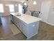 Spacious kitchen island featuring light countertops, ample storage, and seating for casual dining at 1311 Arena Ln, Fuquay Varina, NC 27526