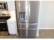 Modern stainless steel refrigerator with a built-in water and ice dispenser at 1311 Arena Ln, Fuquay Varina, NC 27526